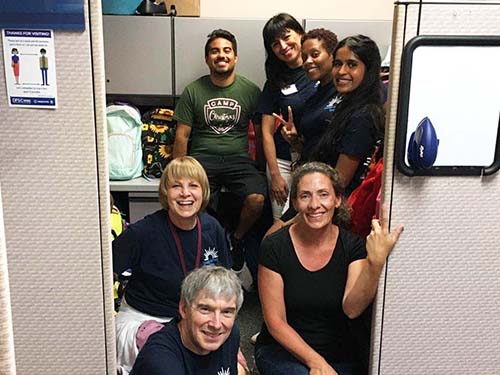 "Christmas is Not Cancelled" backpack drive seven people in group photo