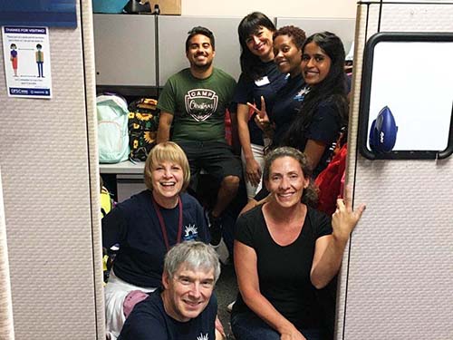 "Christmas is Not Cancelled" backpack drive seven people in group photo