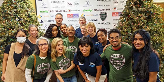 "Christmas is Not Cancelled" backpack drive thirteen people in group photo