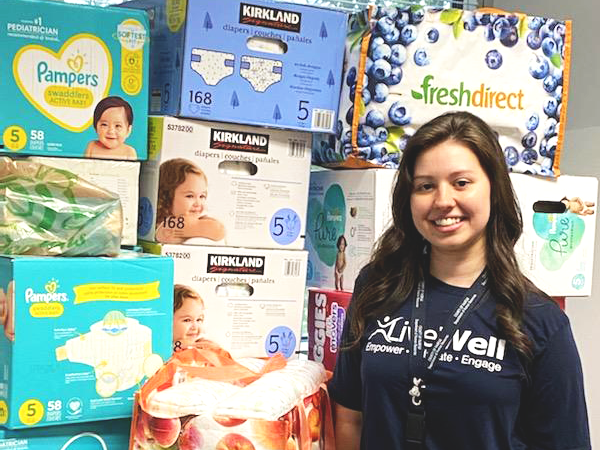 LiveWell diaper drive person standing next to diaper boxes