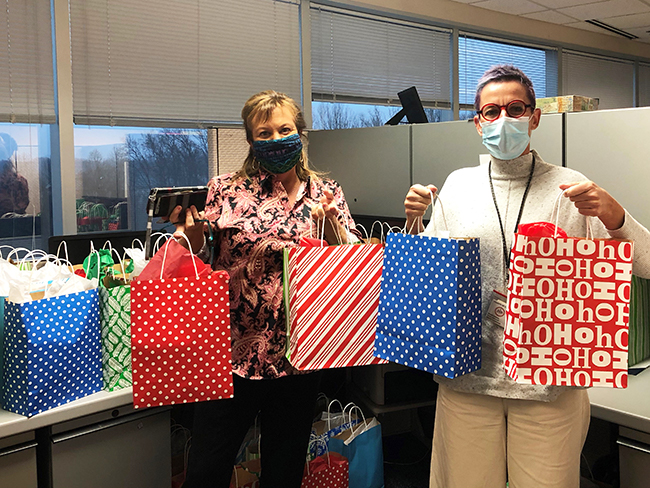 two people holding gift bags