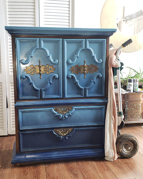 blue armoire on hand truck