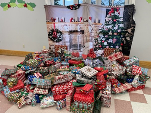 wrapped gifts in front of fireplace