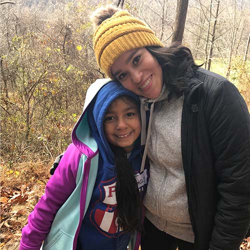 mentor hugging girl on hike