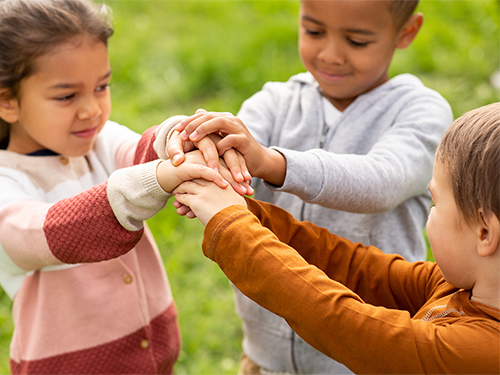 three children holding hands