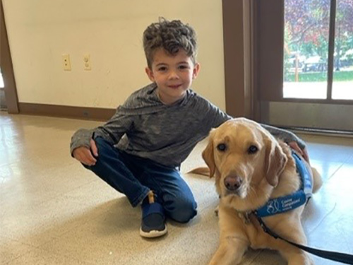 Clifton Preschool Body Safety Class: young boy petting dog