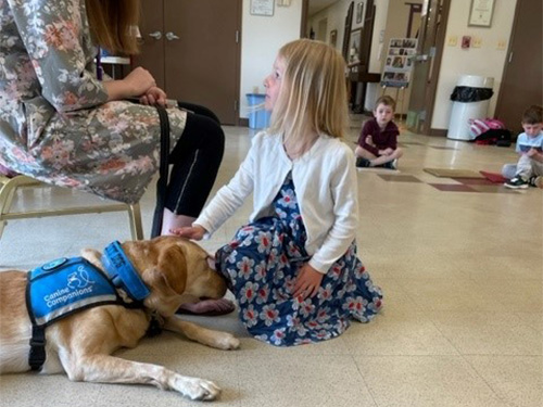 Clifton Preschool Body Safety Class: young girl petting dog