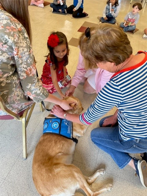 Clifton Preschool Body Safety Class: young girl petting dog