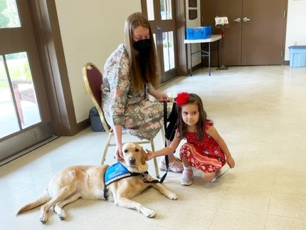 Clifton Preschool Body Safety Class: young girl petting dog