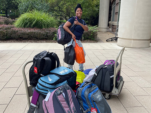 woman holding backpacks