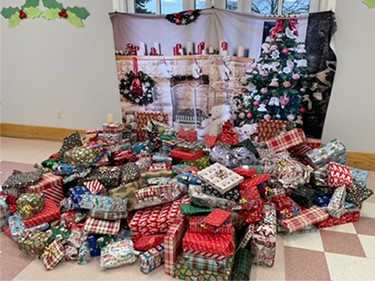 presents in front of holiday backdrop