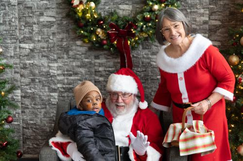 young boy with Santa and Mrs. Claus