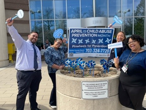 admins planting pinwheels in pennino garden