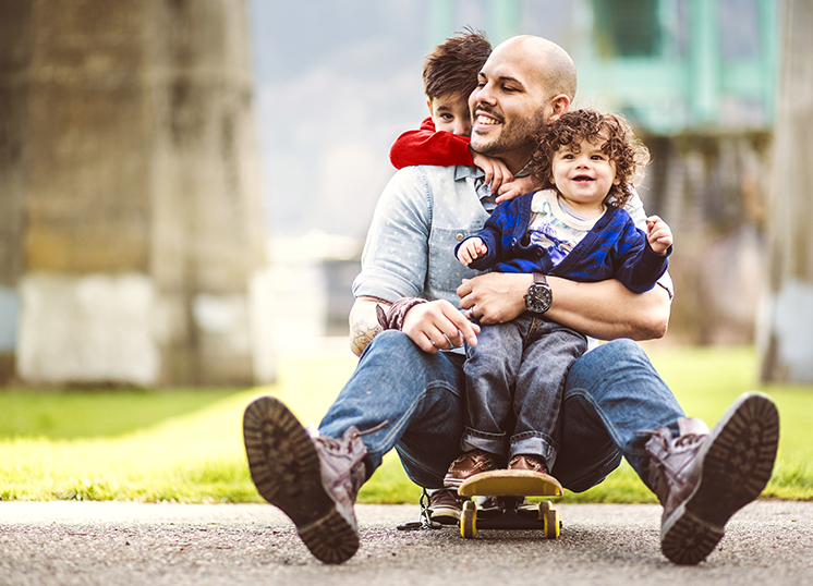 adult and two children on skateboard