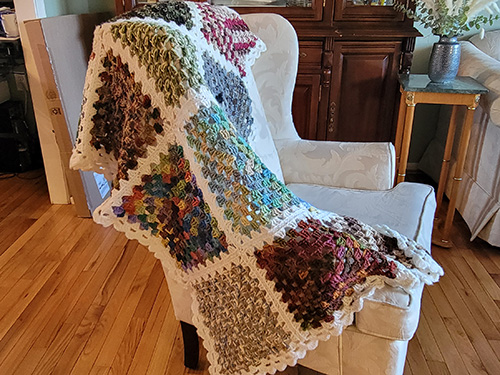 knitted blanket draped over chair