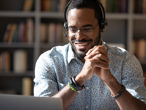 young man using computer with headphones
