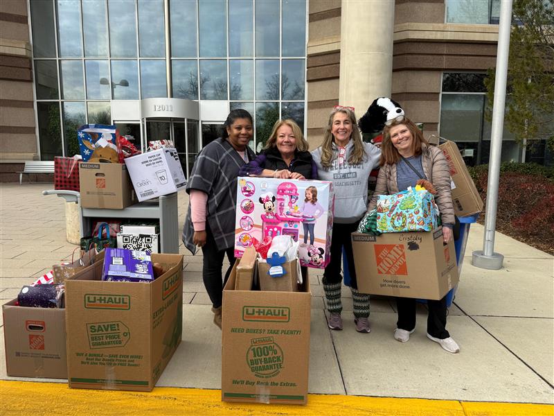 staff with Adopt-A-Family donations