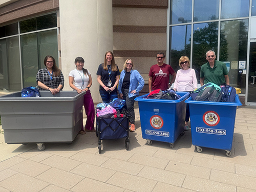 staff with backpack donations