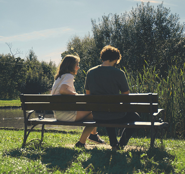 couple sitting outside on park bench
