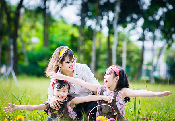 mother and two daughters playful outdoors