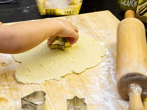 child using star-shaped cookie cutter