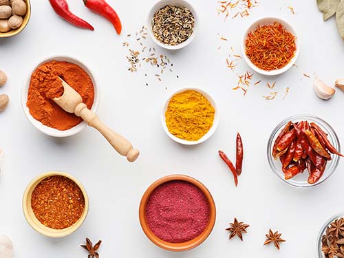 variety of spices in bowls on table