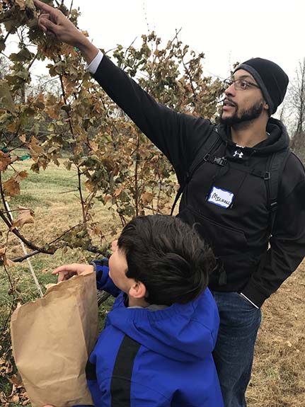 mentor and child picking fruit