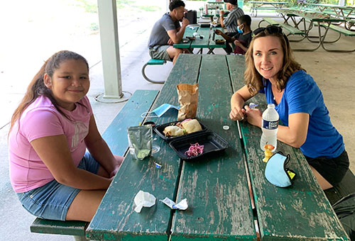 mentor and child at table