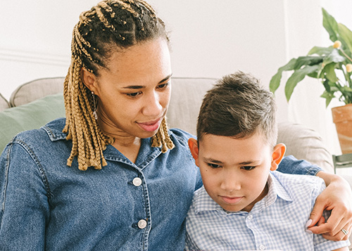 mom and son sitting together and looking down