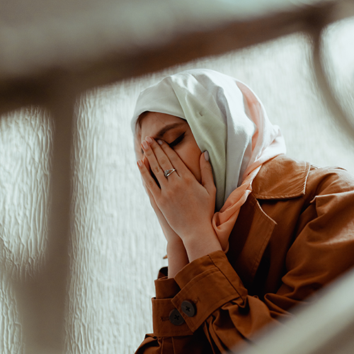 woman with hands over face