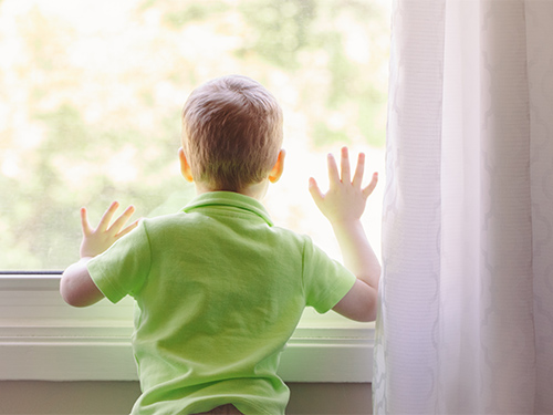 boy looking out window