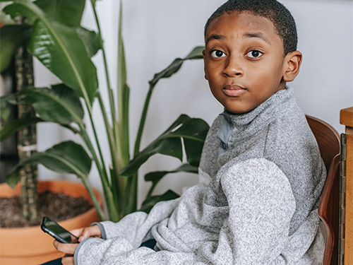 boy surprised holding phone