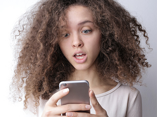 girl smiling holding tablet