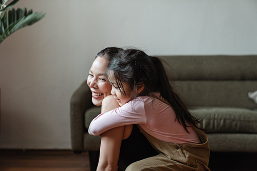 woman and young girl smiling