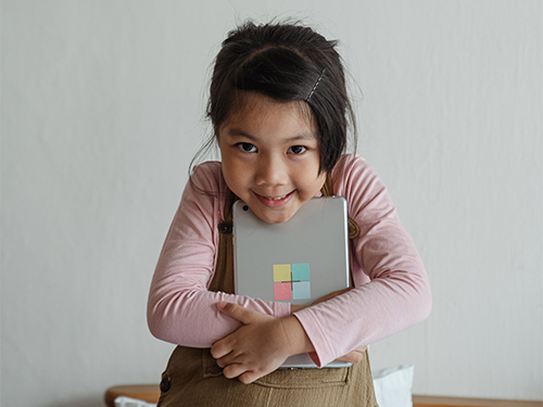 smiling girl holding tablet