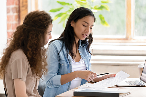 two women looking over paperwork