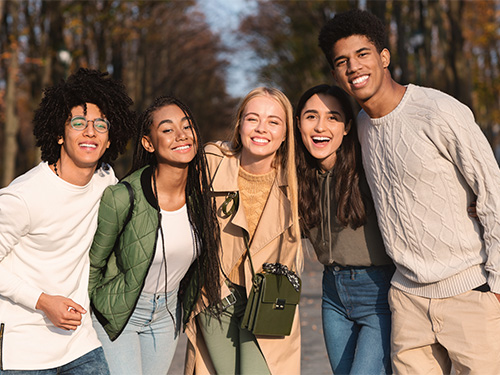 group of five teens smiling