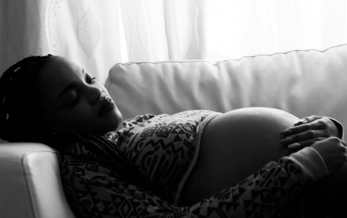 pregnant woman laying on couch