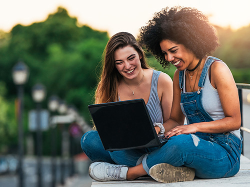 teen girls looking at laptop