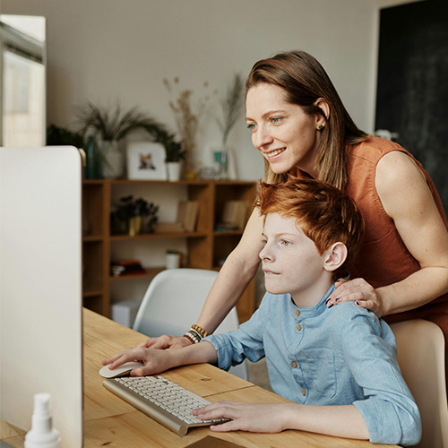 woman standing child using computer