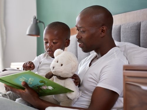 boy father reading bedtime story