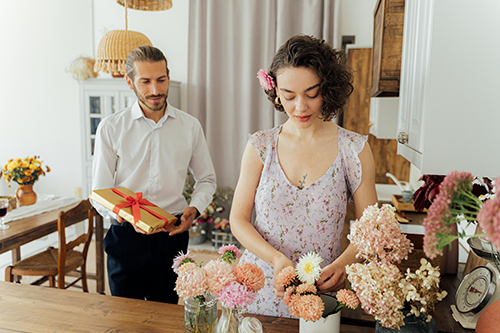 man giving woman a wrapped gift