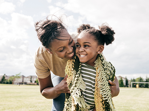 smiling mom and daughter wearing scarf
