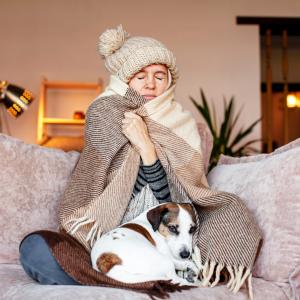 woman wearing coat and hat on couch
