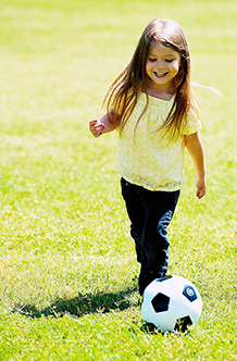 child playing soccer