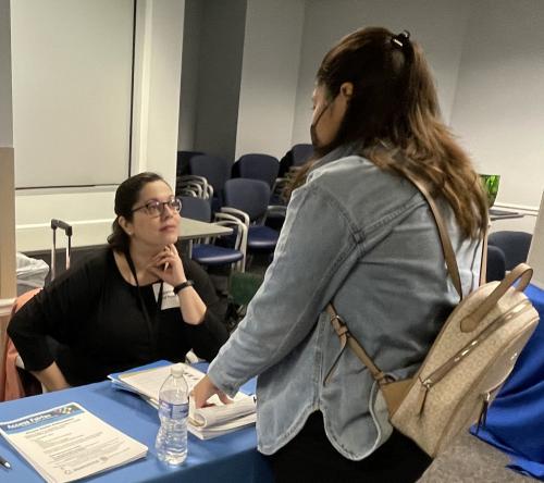 Disability Rights and Resources Manager, Claudia Vila, speaks to a student about disability advocacy and resources. 