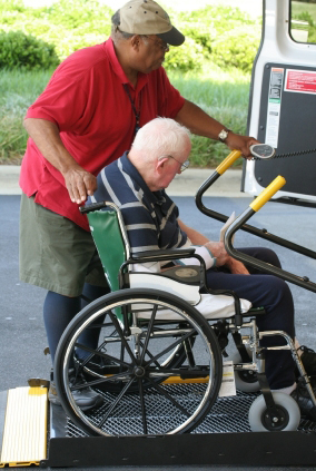 Paratransit-driver-helping-wheelchair-user-board-vehicle