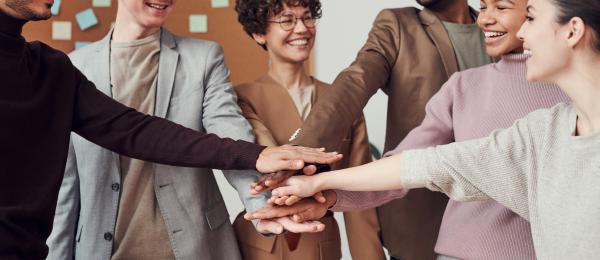 A group of people with stacked hands