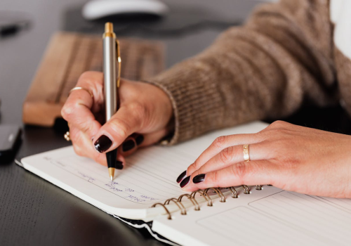 woman writing in journal 
