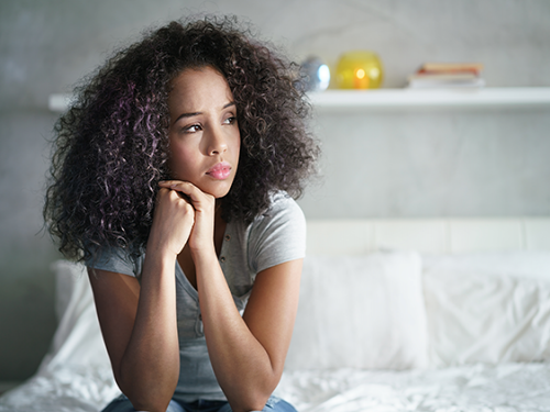 woman sitting on bed